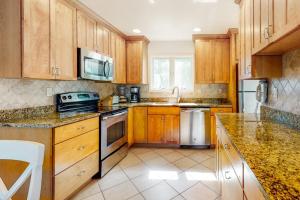 a kitchen with wooden cabinets and stainless steel appliances at Sea Colony - 1004D Brighton Vw in Bethany Beach