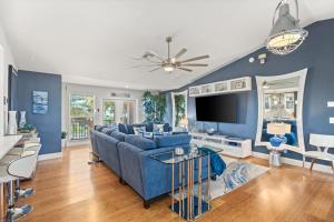 a living room with a blue couch and a tv at Coastal Escape in Saint James City