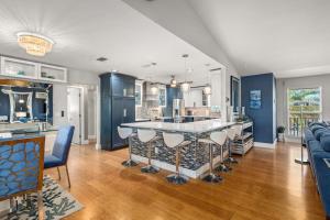 a kitchen and living room with a bar and a couch at Coastal Escape in Saint James City