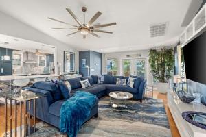 a living room with a blue couch and a kitchen at Coastal Escape in Saint James City