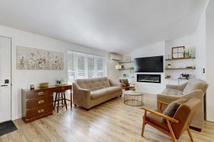 a living room with a couch and a tv at Whispering Pines in Wisconsin Dells