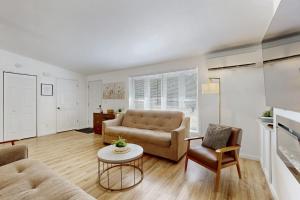 a living room with a couch and a table at Whispering Pines in Wisconsin Dells