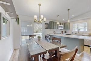 a dining room and kitchen with a table and chairs at Whispering Pines in Wisconsin Dells +17 photos