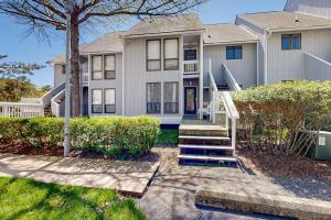 a large white house with stairs in front of it at Sea Colony --- 3404 Round Robin Way in Bethany Beach