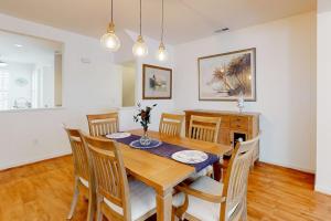a dining room with a wooden table and chairs at Bear Trap Dunes 132H October Glory Ave in Ocean View