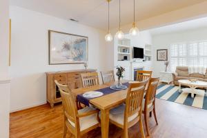a dining room and living room with a table and chairs at Bear Trap Dunes 132H October Glory Ave in Ocean View +36 photos