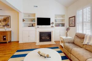 a living room with a couch and a fireplace at Bear Trap Dunes 132H October Glory Ave in Ocean View