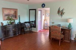 a living room with a desk and a chair at Franzone Fun in Saint James City