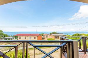 a view from the balcony of a house at Oceanview Terrace, Walk to Beach, WiFi and Parking in Saint Lucy +16 photos