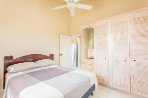 a bedroom with a bed and a ceiling fan at Oceanview Terrace, Walk to Beach, WiFi and Parking in Saint Lucy
