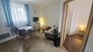 a small living room with a table and a couch at Vilka Čachtice in Čachtice