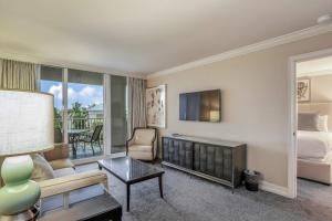 a hotel room with a bed and a living room at Marco Beach Ocean Resort Condominiums #605 in Marco Island