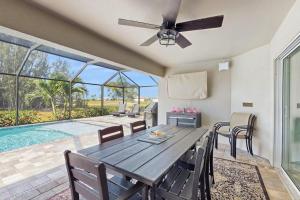 a dining room with a table and a ceiling fan at Cocktail Cove in Cape Coral