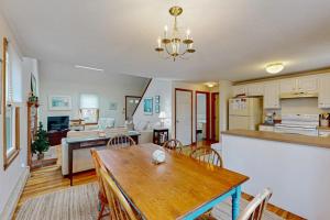 a kitchen and living room with a table and a dining room at Skylight Tonight in South Dennis