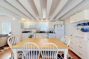 a kitchen with a wooden table and chairs at Oak Bluffs Cottage in Oak Bluffs