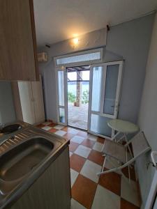a kitchen with a sink and a table in it at Lana Seafront Apartments in Šušanj +100 photos