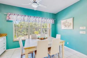 a dining room with a table and chairs and a window at Tranquil Haven in Marco Island