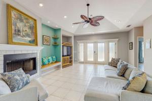 a living room with two couches and a fireplace at Tranquil Haven in Marco Island