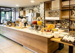 a kitchen with a long counter with food on it at Bianco Hotel Boutique in Cúcuta