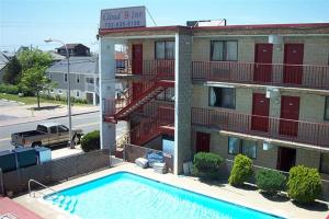 a large swimming pool in front of a building at Cloud 9 Inn - Beach Hotel in Seaside Heights