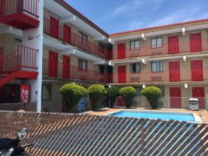 an apartment building with a swimming pool in front of it at Cloud 9 Inn - Beach Hotel in Seaside Heights