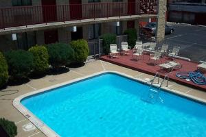 a large blue swimming pool in a hotel yard at Cloud 9 Inn - Beach Hotel in Seaside Heights +3 photos