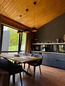 a dining room with a table and chairs and a kitchen at Мої Гори in Pilipets