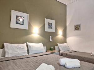 a hotel room with two beds with white pillows at Apartments Papadioti in Pefki