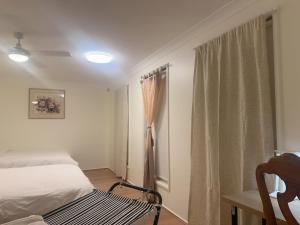 a bedroom with a bed and a window at Private Room-2Queen beds in Elderslie