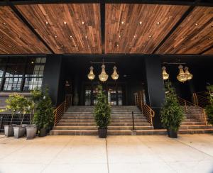 a building with a staircase with potted plants and lights at Sela V Hotel in Brooklyn
