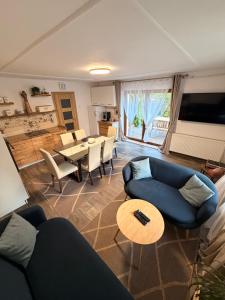 a living room with a blue couch and a table at Chalupa U Franze in Malá Morava