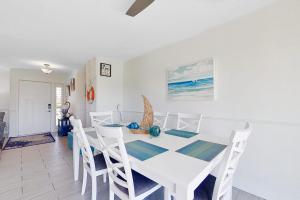 a white dining room with a white table and chairs at Southwest Florida Sanctuary in Cape Coral