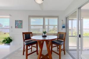 a dining room with a table and four chairs at Southwest Florida Sanctuary in Cape Coral +21 photos