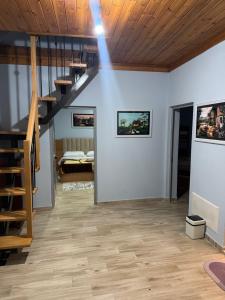a living room with a staircase and a bedroom at Imperio Boge Hotel in Bogë