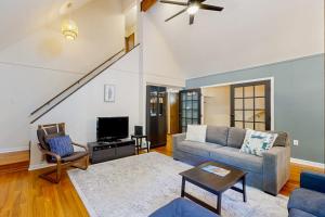 a living room with a couch and a tv at Battersea on the Canal in Ocean Pines