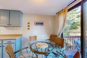 a kitchen with a glass table and chairs at Battersea on the Canal in Ocean Pines