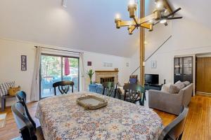 a dining room with a table and a living room at Battersea on the Canal in Ocean Pines