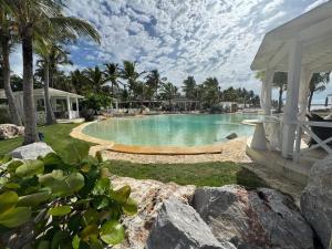 a swimming pool with a gazebo next to a resort at Penthouse In Tracadero Oceanfront Infinity Pool in La Laguna