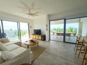 a living room with a couch and a table at Penthouse In Tracadero Oceanfront Infinity Pool in La Laguna