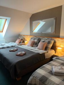 a bedroom with two beds and a window at Penzion Amfik in Mikulov