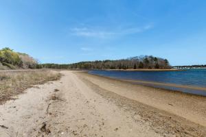 a dirt road next to a body of water at Buttermilk Bliss in Wareham