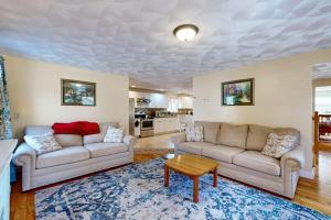 a living room with two couches and a table at Buttermilk Bliss in Wareham