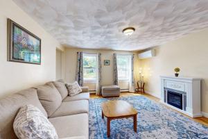 a living room with a couch and a fireplace at Buttermilk Bliss in Wareham