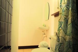 a small bathroom with a toilet and a sink at The Landing Hotel And Restaurant in Moyogalpa +31 photos