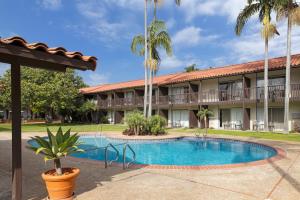 a resort with a swimming pool in front of a building at FOUND Hotels, Santa Barbara, Series by Marriott in Santa Barbara