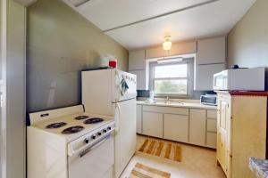 a kitchen with a stove and a white refrigerator at Green Cottage Getaway in Frankfort