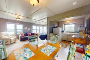 a kitchen and a living room with a table and chairs at Green Cottage Getaway in Frankfort