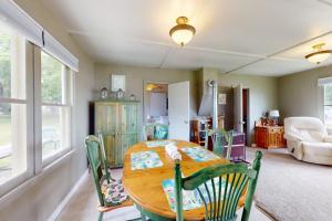 a dining room with a wooden table and chairs at Green Cottage Getaway in Frankfort