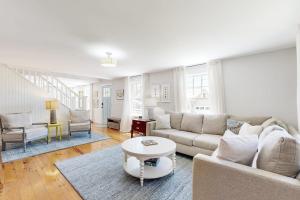 a living room with a couch and a table at Blissful Island Haven in Oak Bluffs