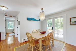 a dining room with a wooden table and chairs at Blissful Island Haven in Oak Bluffs